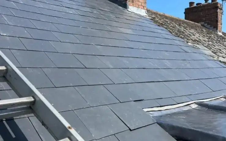 New grey slate laid around a brick chimney, one of our jobs