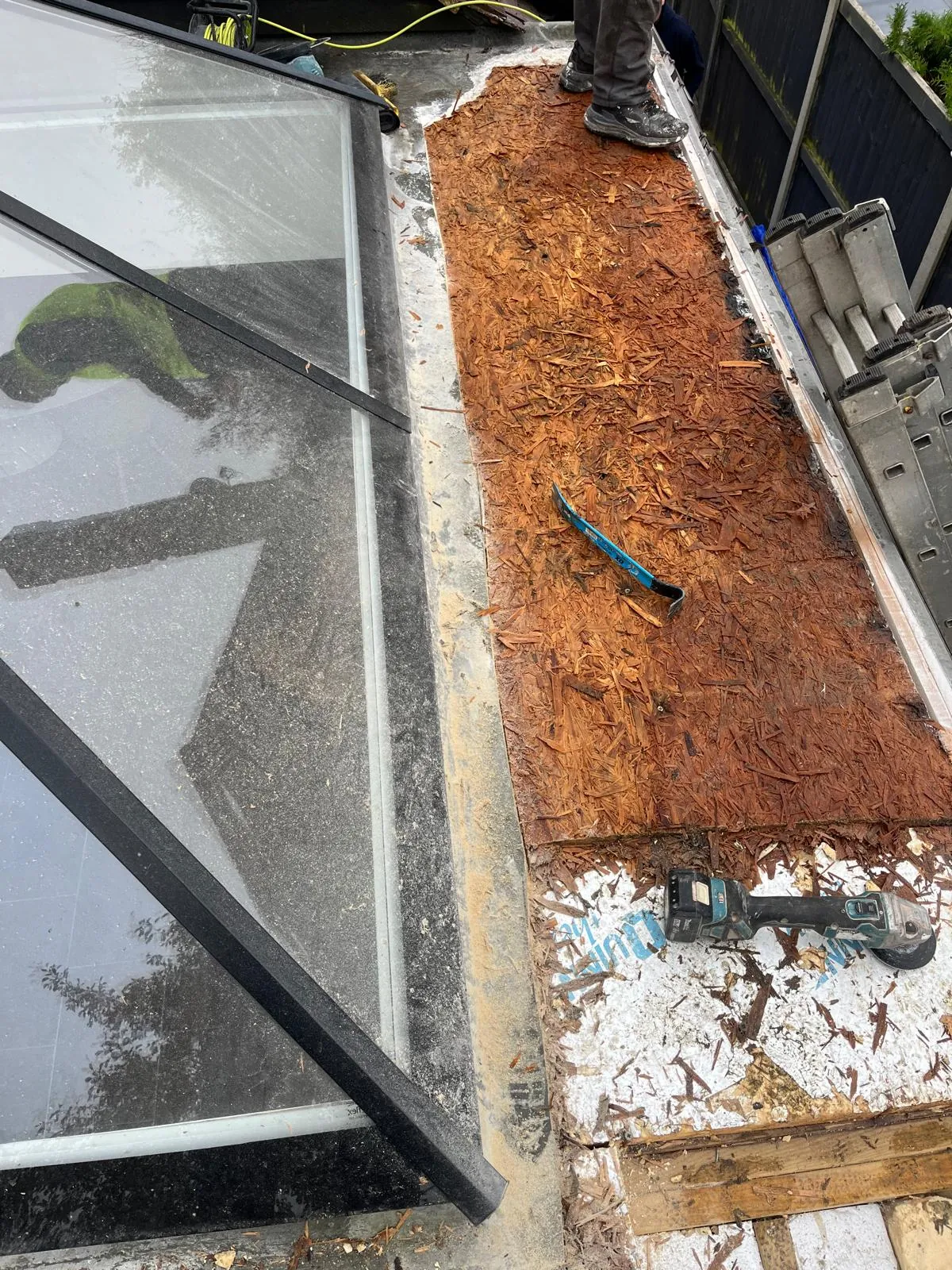 Flat roof deck stripped back beside a glass roof lantern