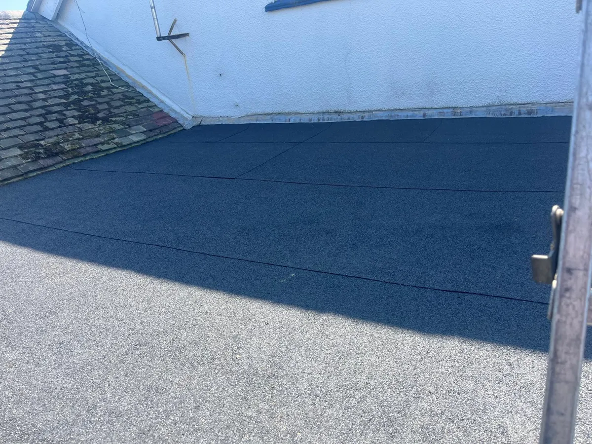 Large flat roof re-covered in grey mineral felt