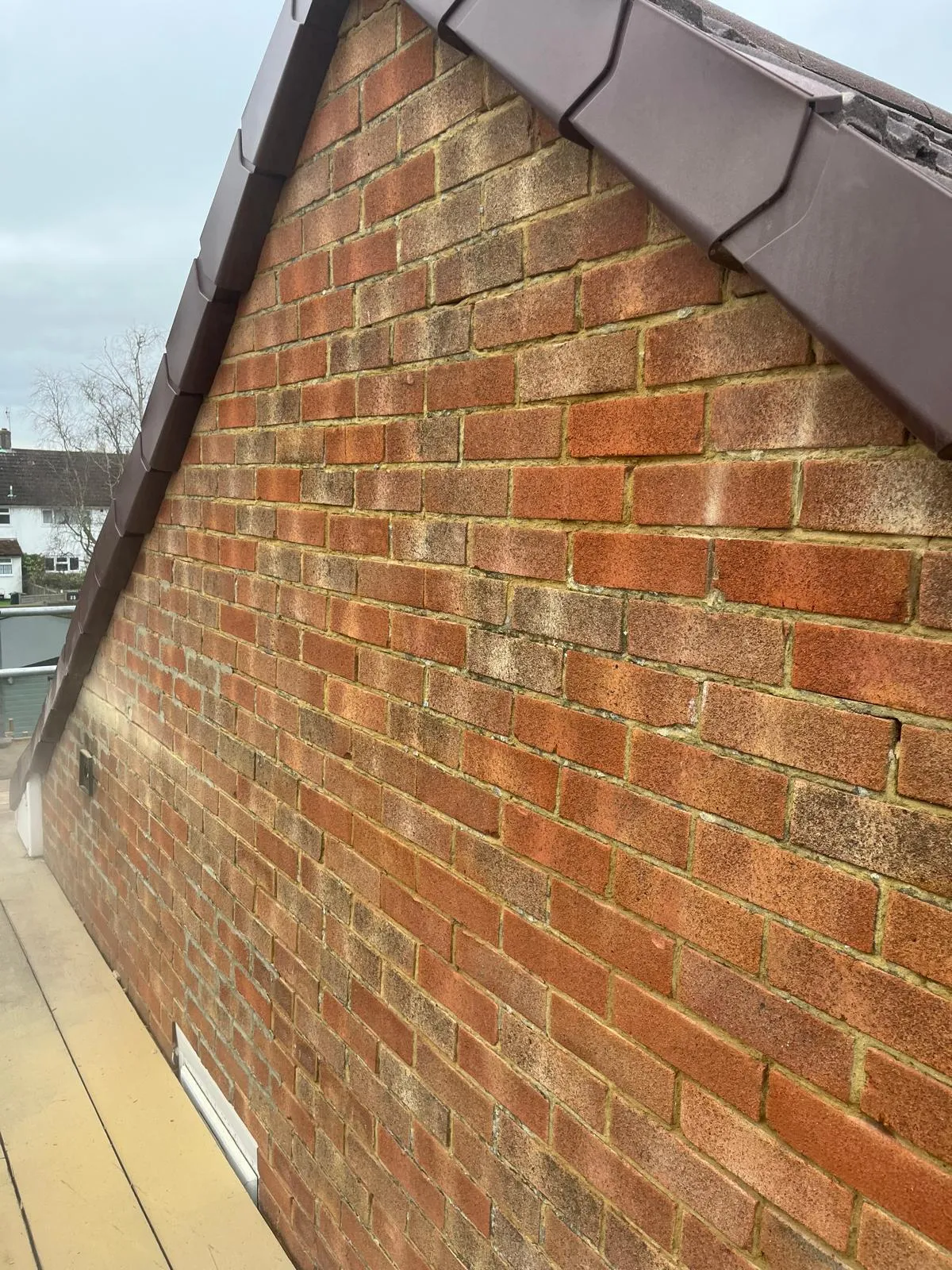 Gable end brickwork finished under a new verge