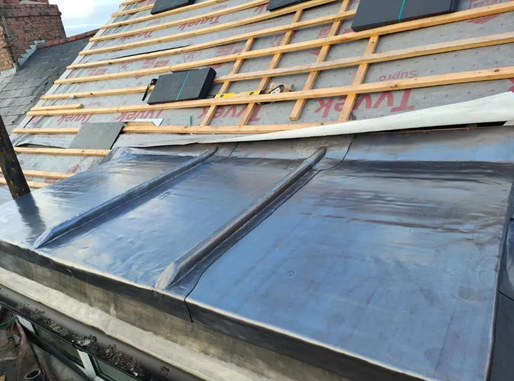 New lead valley dressed into a slate roof