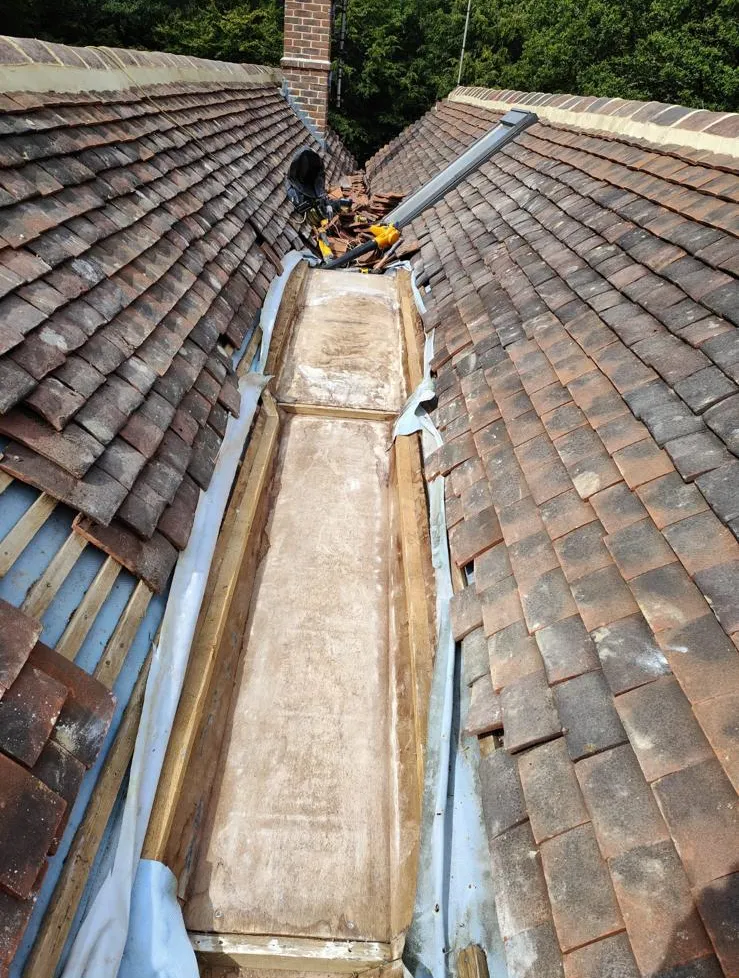 New lead valley running between two tiled roof slopes