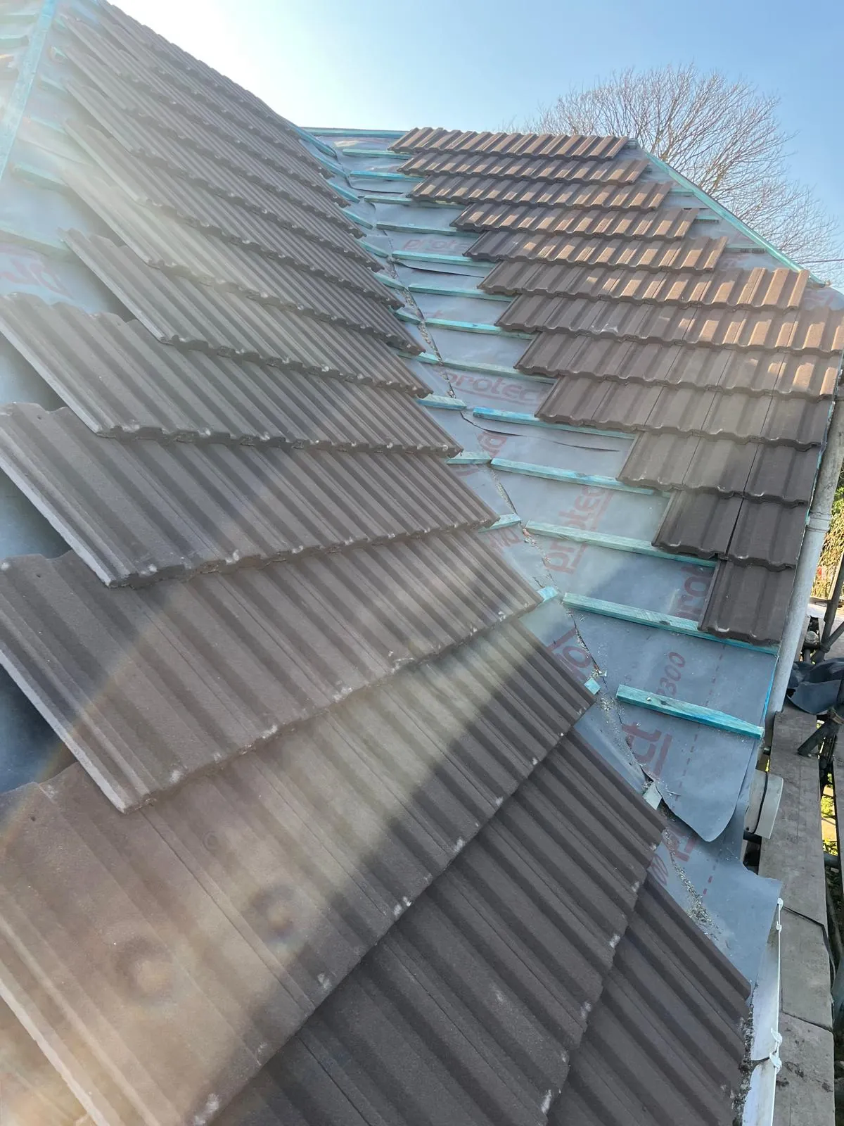 Tiles laid partway up a slope over new battens